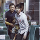 The main characters of Train to Busan, apprehensively walking down a train car.
